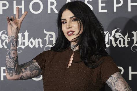 Kat Von D covers herself in black tattoo work after。